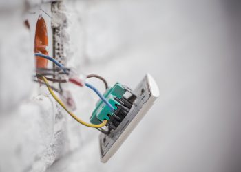 Electric Outlet Installation Closeup Photo. Concrete Brick Wall Outlet.