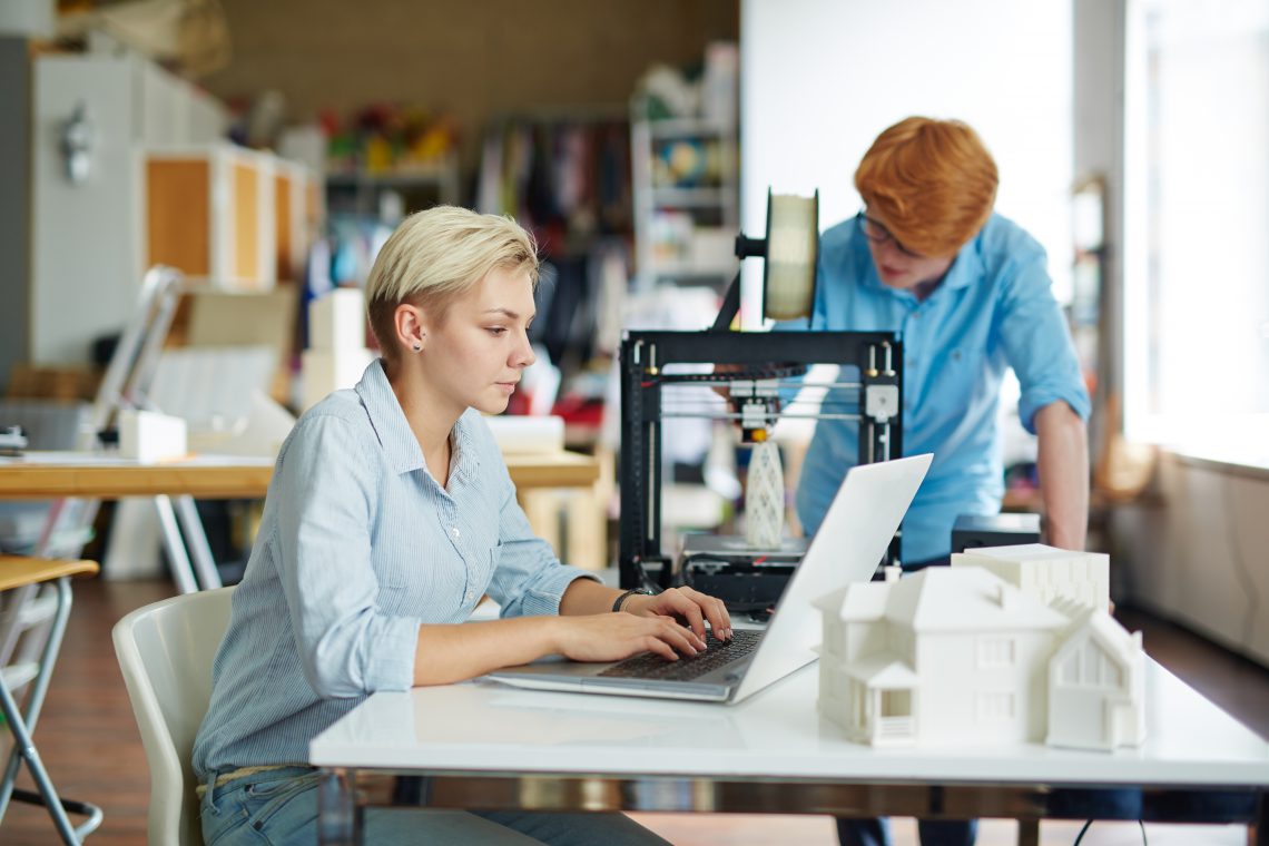 Pretty engineer typing at workplace