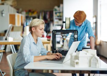 Pretty engineer typing at workplace