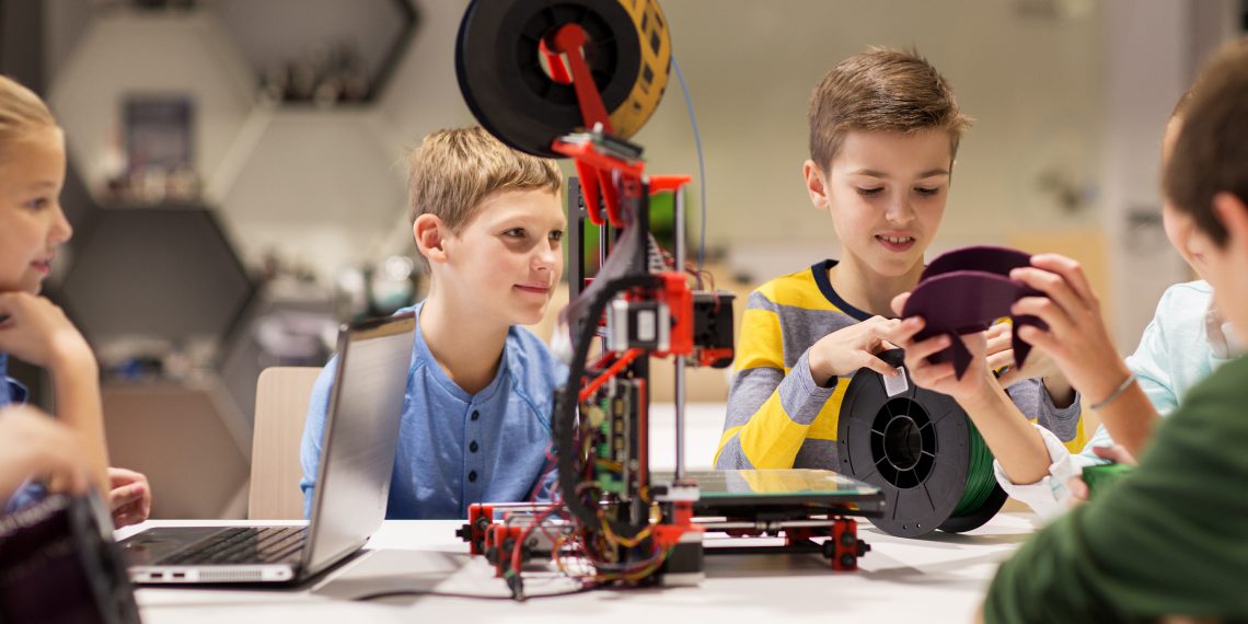 education, children, technology, science and people concept - group of happy kids with 3d printer at robotics school lesson