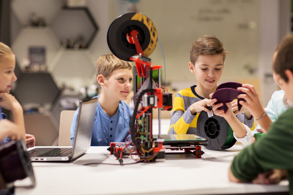 education, children, technology, science and people concept - group of happy kids with 3d printer at robotics school lesson