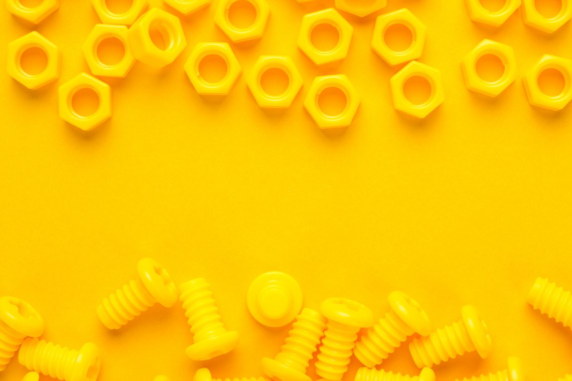 3d printed bolts and nuts on yellow background