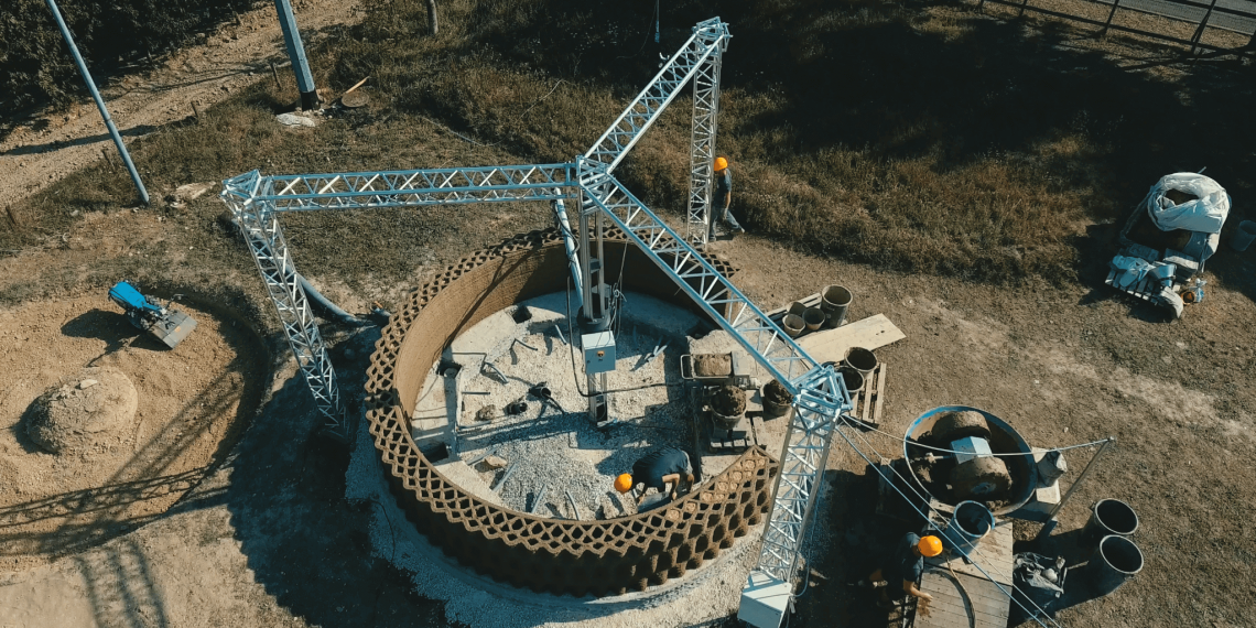 Overhead view of GAIA construction site with a delta style construction 3D printer. Photo curtesy of WASP.