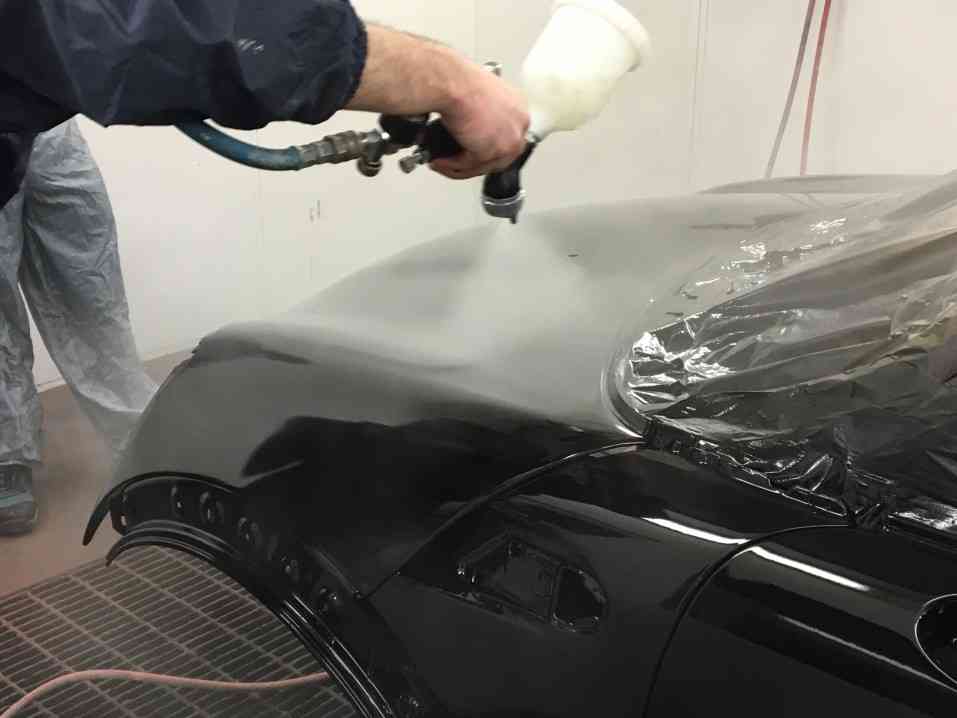 Spray painting clear coat onto car body shell