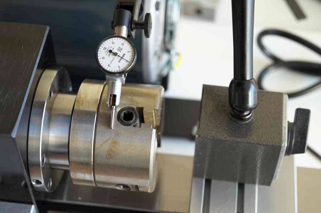 Setting up a dial test indicator for measuring runout on lathe. Photo credit: John L.